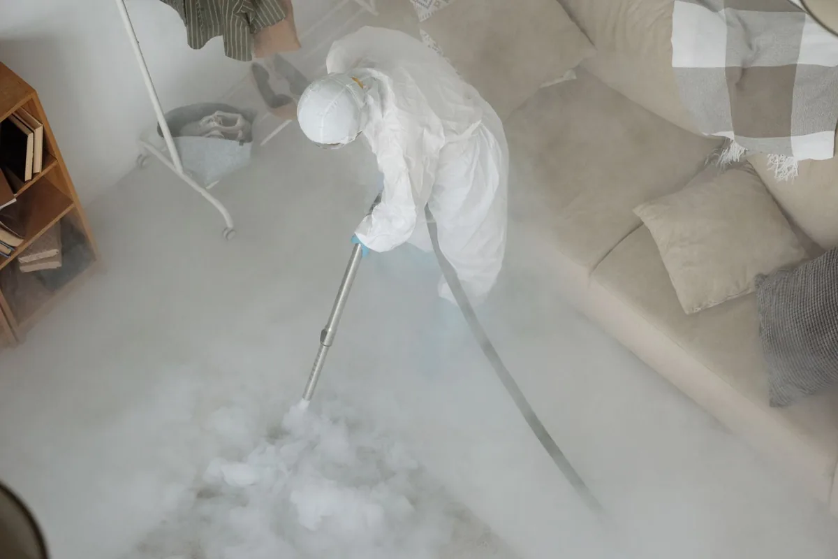 Biohazard cleanup technician in protective equipment, Kansas City, KS